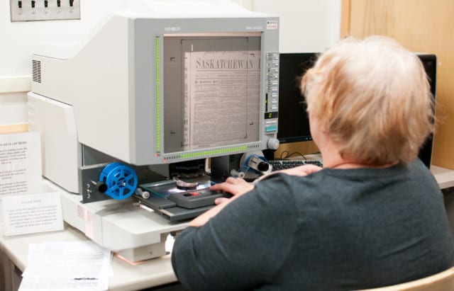 Marion Ghiglione uses a microfilm machine at the office on campus. 