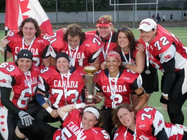 Jessie Buydens (top left) waves the Canadian flag after her team placed second at the first women’s football World Championship in 2010.