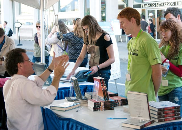 Life of Pi author Yann Martel talks with readers and volunteers at the signing tent.