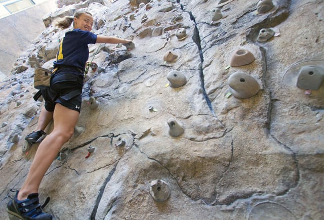 Nicole Nagy climbs the 40-foot rock wall at the Physical Activity Complex.