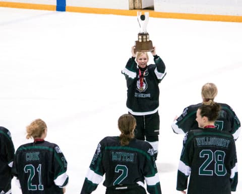 The Huskies women’s hockey team hoists the Canada West trophy for the first time.