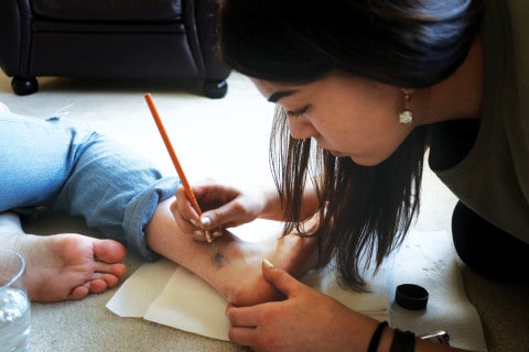 Mackenzie getting her tattoo as a stick and poke by artist Stephanie Mah on October 17.