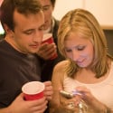 people looking at their smartphones at a party
