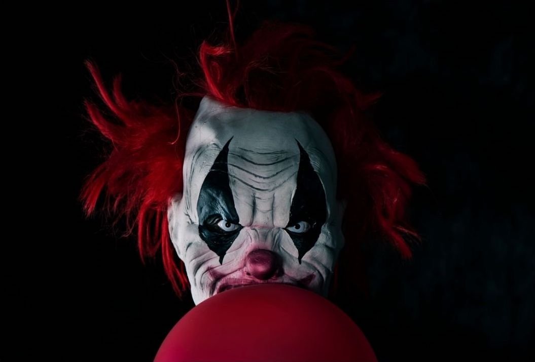 Scary evil clown with a balloon | nito100 from Getty Images Signature | Canva Pro