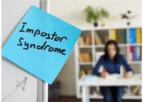 Imposter syndrome written on the sticker on the whiteboard| designer491 from Getty Images Signature | Canva Pro