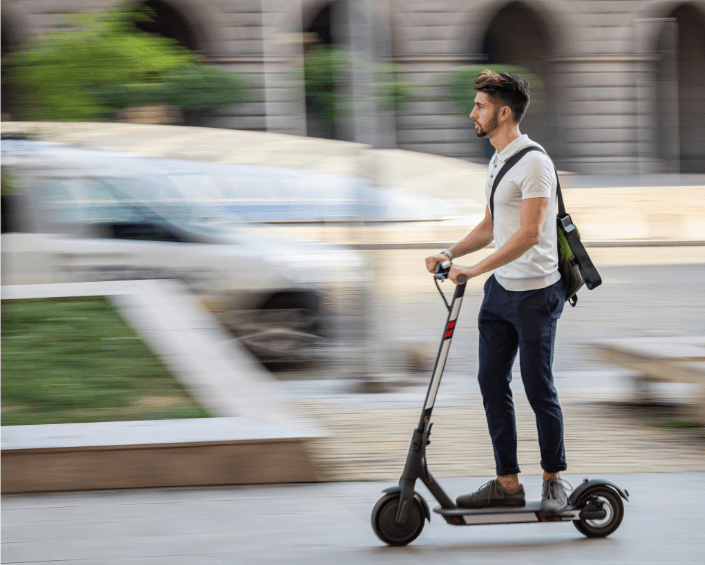 Student commuting with e-scooter| Petko Ninov from Getty Images Signature | Canva Pro