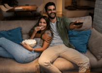 Couple on Sofa Watching TV | Martinns from Getty Images Signature | Canva Pro