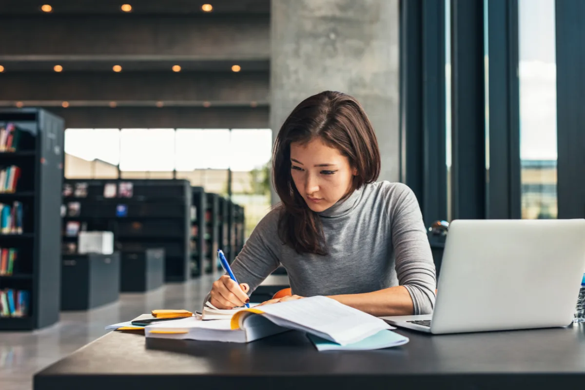 Female student studying at College Library| Jacob Lund | Canva Pro