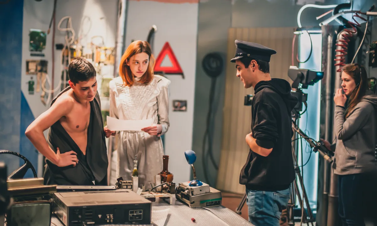 Behind the scene. Film crew filming movie scene in studio. | guruXOOX Getty Images | Canva Pro