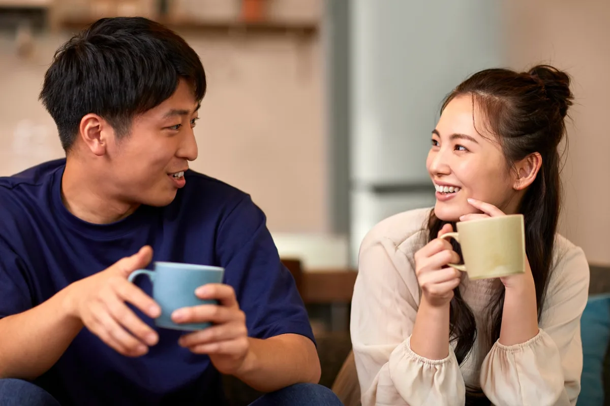 Couple enjoying coffee and conversation. | Aflo Images | Canva Pro