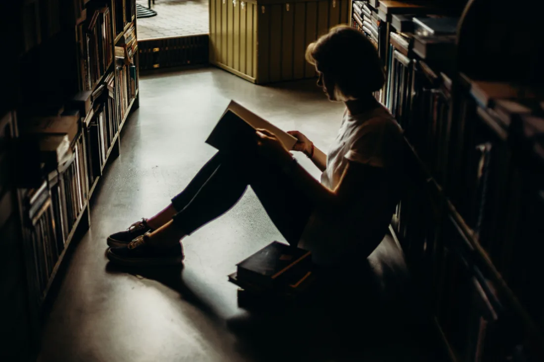 A woman sitting on the floor reading a book | Cottonbro Studio from Pexels | Canva Pro