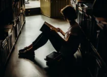 A woman sitting on the floor reading a book | Cottonbro Studio from Pexels | Canva Pro