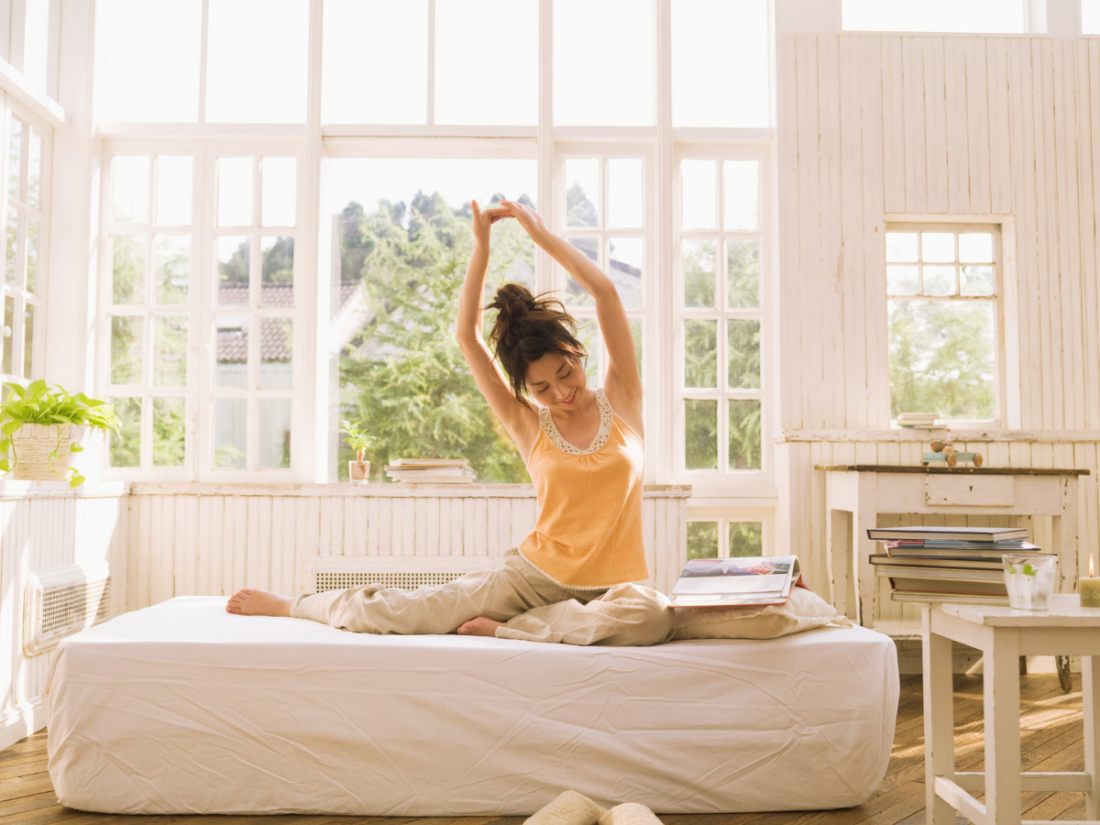 Morning stretch in a sunlit room| Aflo Images| Canva Pro