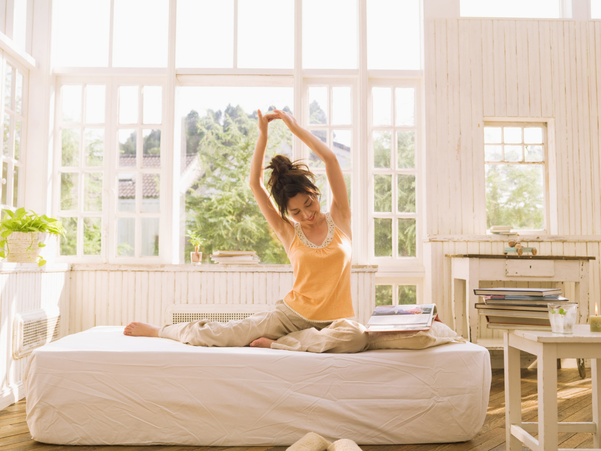 Morning stretch in a sunlit room| Aflo Images| Canva Pro