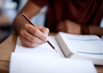 Closeup shot of a student writing| peopleimages.com | Canva Pro