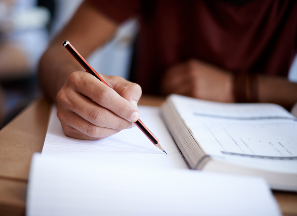 Closeup shot of a student writing| peopleimages.com | Canva Pro